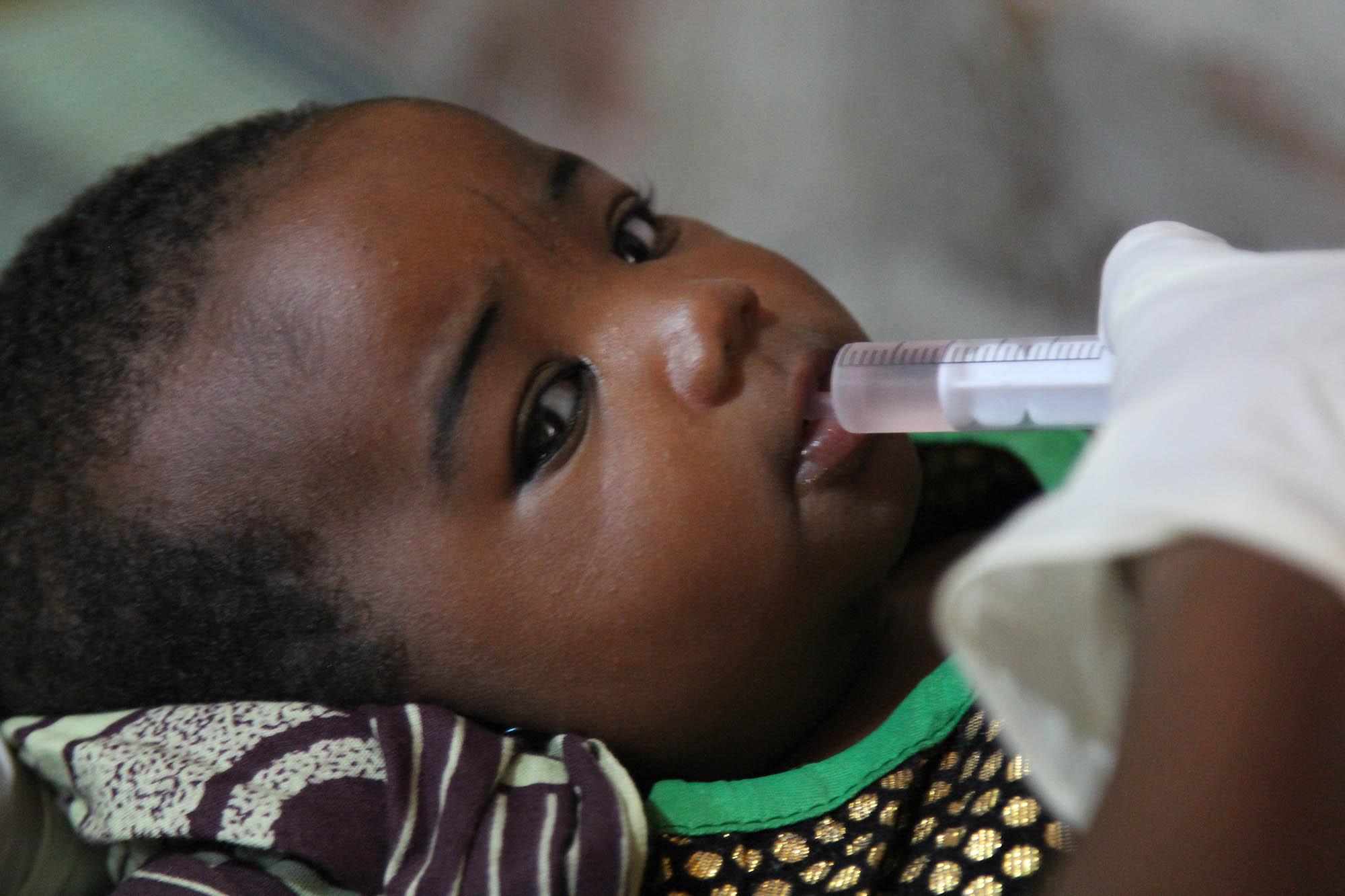Child receives oral vaccine against rotavirus, Niger.